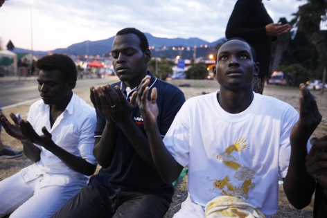  VENTIMIGLIA, ITALY - JUNE 16:Migrants stay on rocks as they wait to cross into France,in the French-Italian border,on June 16, 2015 in Ventimiglia, Italy.Some 200 migrants from Africa are being blocked by French authorities to enter the country from Ventimiglia in Italy since June 11.(Photo by Patrick Aventurier)