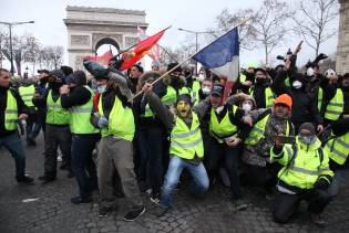  PARIS, FRANCE - DECEMBER 08:Gilets jaune demonstrators clash with police on the Champs Elysees near the Arc de Triomphe on December 8, 2018 in Paris France. ''Yellow Vests' ('Gilet Jaunes' or 'Vestes Jaunes') is a protest movement without political affiliation which was inspired by opposition to a new fuel tax. After a month of protests, which have wrecked parts of Paris and other French cities, there are fears the movement has been infiltrated by 'ultra-violent' protesters. Today's protest has involved at least 8,000 demonstrators gathering in the Parisian city centre with police having made over 1150 arrests.   (Photo by Patrick Aventurier/Gamma)