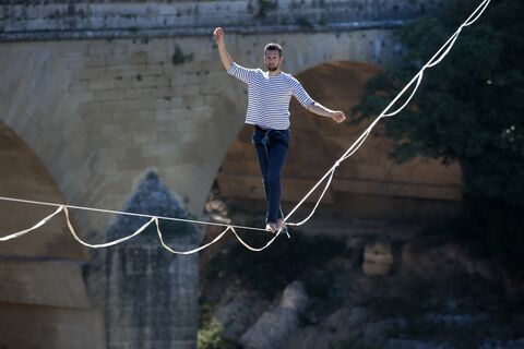  VERS-PONT-DU-GARD, FRANCE - JULY 09:French tightrope walker Nathan Paulin walk on a slackline at the Pont du Gard, a Roman aqueduct bridge part of the UNESCO's list of World Heritage Site, in Vers-Pont-du-Gard southern France, during the Crater Surfaces festival,on July 9, 2022 in Vers-Pont-du-Gard, France. (Photo by Patrick Aventurier/Getty Images)