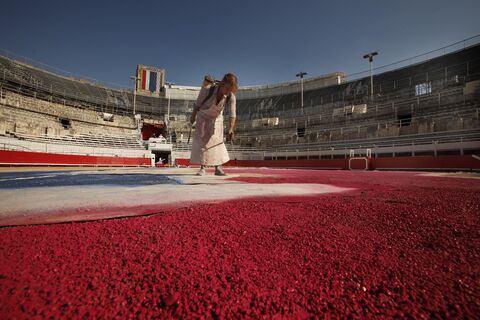  ARLES, FRANCE - SEPTEMBER 10:  The french artist and master of Support-Surfaces art Claude Viallat,on September 10, 2011 in Arles, in the ancient roman arena in Arles preparing the decoration for Goyesca bullfights in the ancient Roman arenas in Arles .The Goyesca bullfights is a colourful display of Goyesca costumes during the the Feria du Riz(Rice Festival).Francisco de la Goya is a famous 18th century Spanish painter. France.  (Photo by Patrick Aventurier)